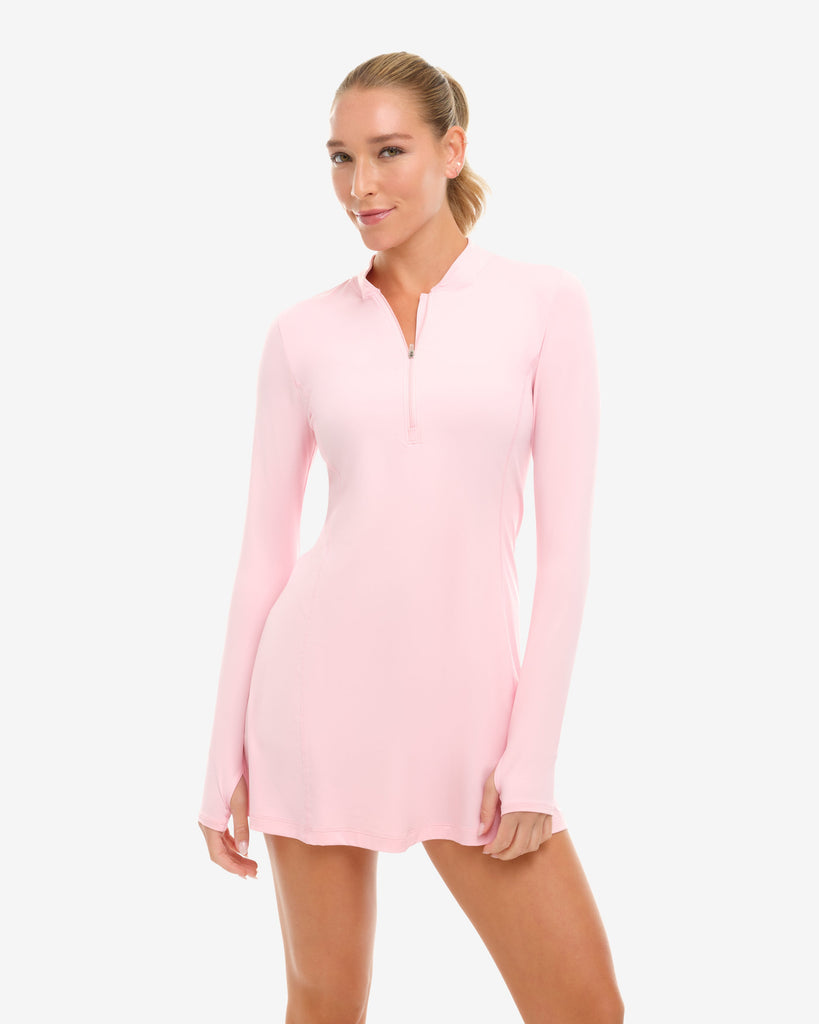 Woman wearing a pink long-sleeve dress on a white background