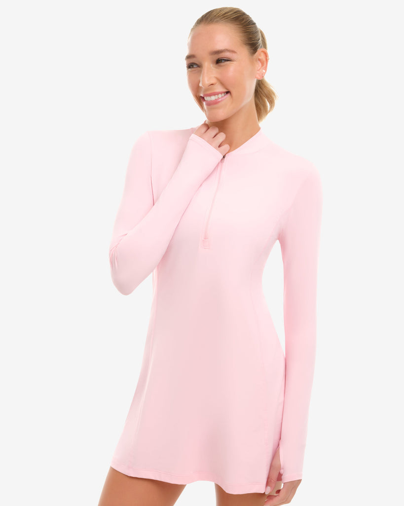 Woman wearing a light pink dress against a white background