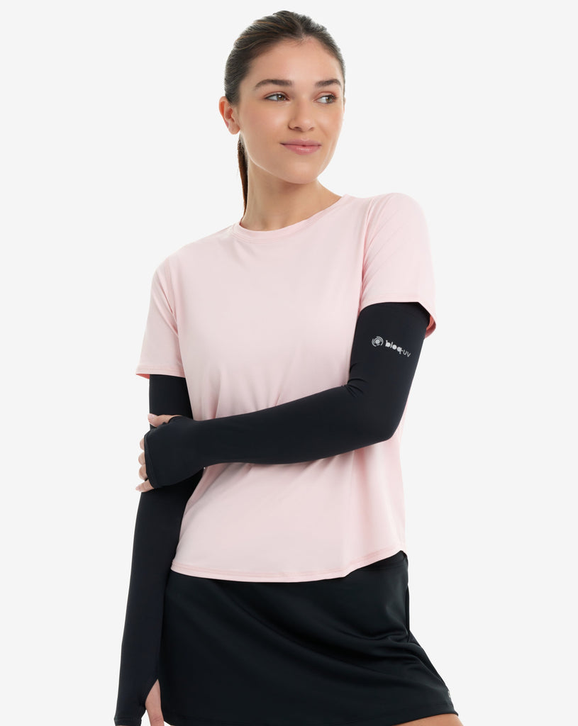 Women wearing tickle me pink short sleeve crew top with black sun sleeves and black skirt. (Style 1101) - BloqUV