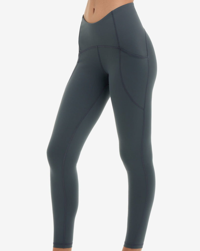 Women wearing compression capri leggings in smoke. Side view showing pocket. (Style 6107) -BloqUV