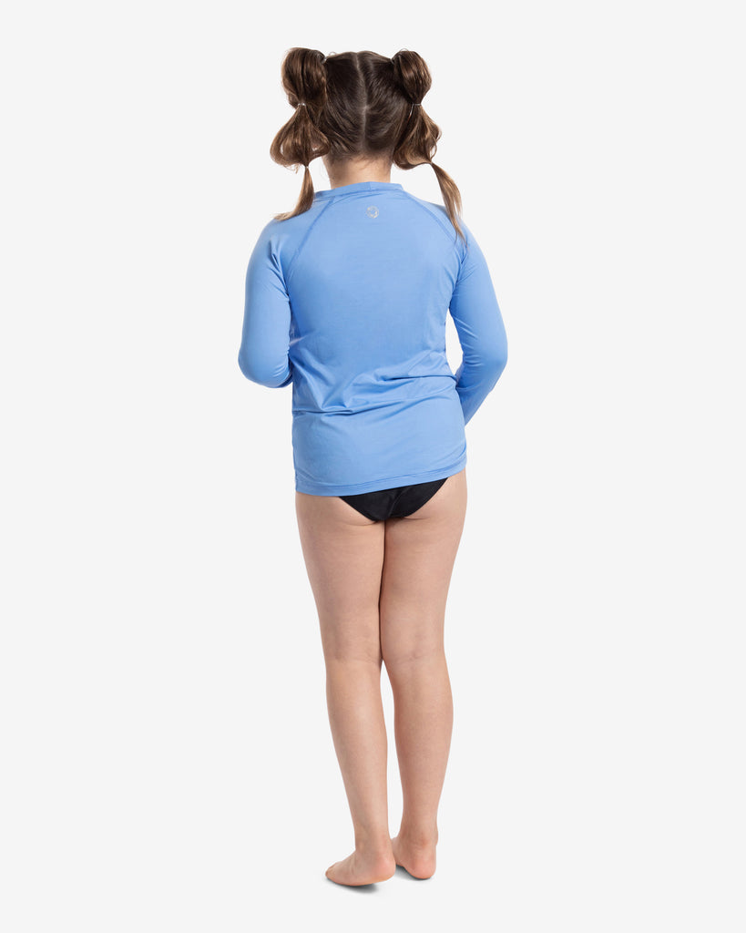 Girl wearing indigo blue color top over a swimsuit. Picture showing the back. (Style 1005K) - BloqUV