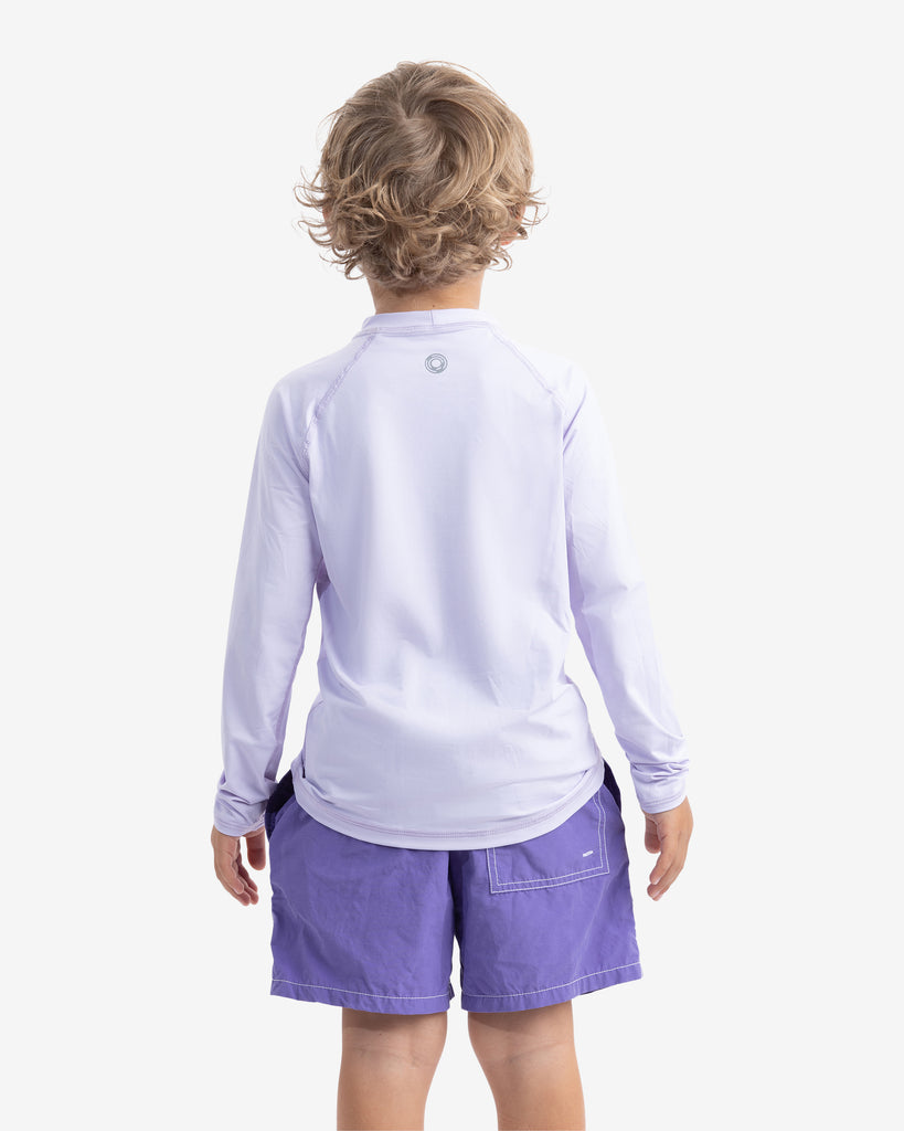 Boy wearing lavender color top with swim shorts. Back of shirt showing. (Style 1005K) - BloqUV