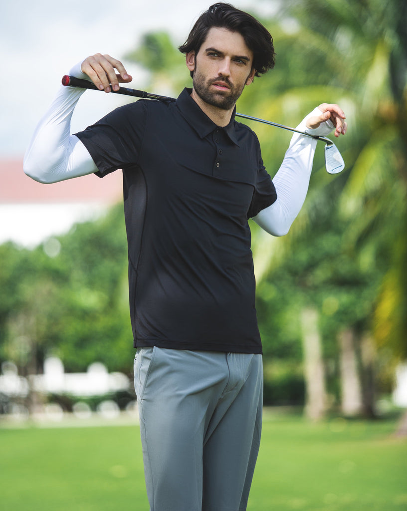 Man playing golf wearing short sleeve polo shirt in black with white sun sleeves. (Style 11004) - BloqUV