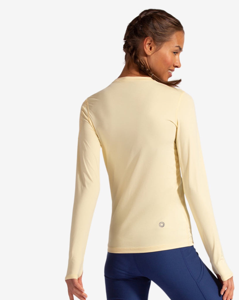 Women wearing lemon yellow long sleeve 24/7 shirt with navy tights. Pictures shows the back of the shirt. (Style 2001) - BloqUV