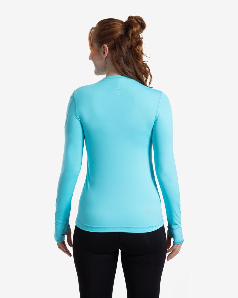 Women wearing light turquoise blue long sleeve 24/7 shirt with black tights. Picture shows back of shirt. (Style 2001) - BloqUV