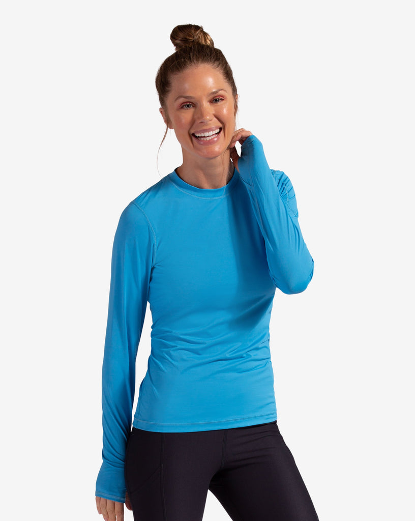 Women wearing ocean blue long sleeve 24/7 shirt with black tights. (Style 2001) - BloqUV