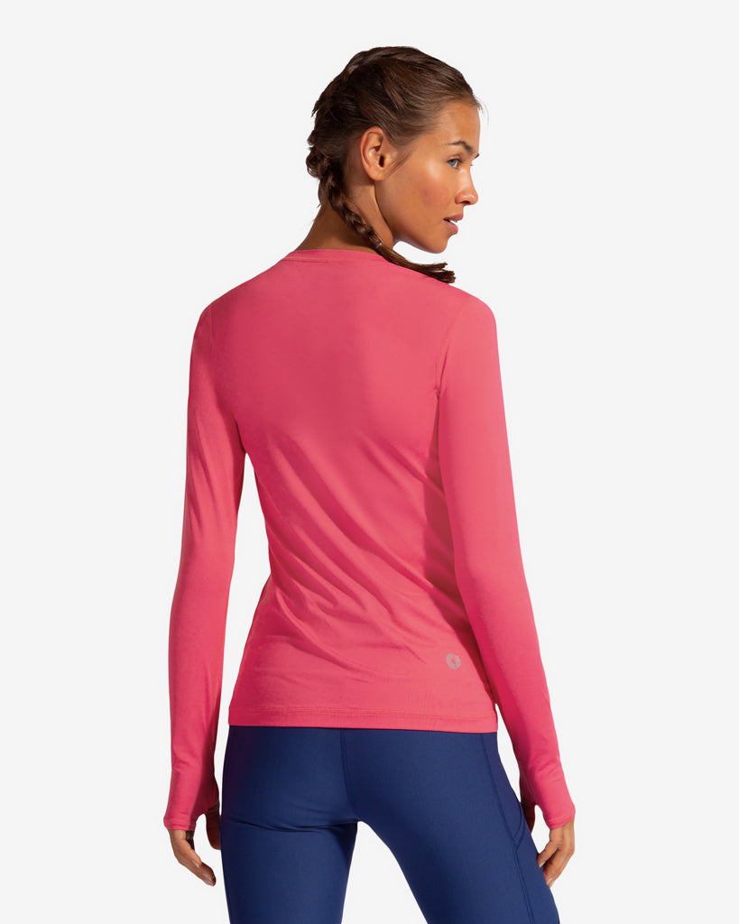 Women wearing watermelon long sleeve 24/7 shirt with navy leggings.  Pictures shows back of shirt.(Style 2001) - BloqUV