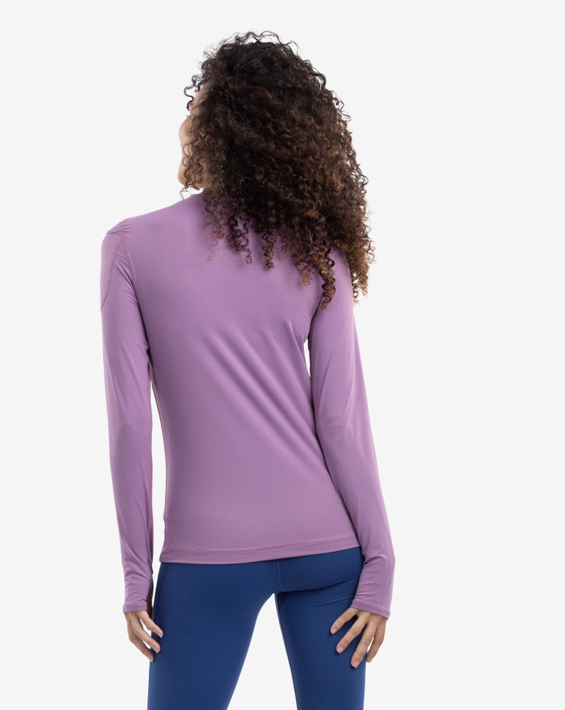 Women wearing pluam long sleeve 24/7 shirt with navy tights. Picture shows back of shirt.(Style 2001) - BloqUV