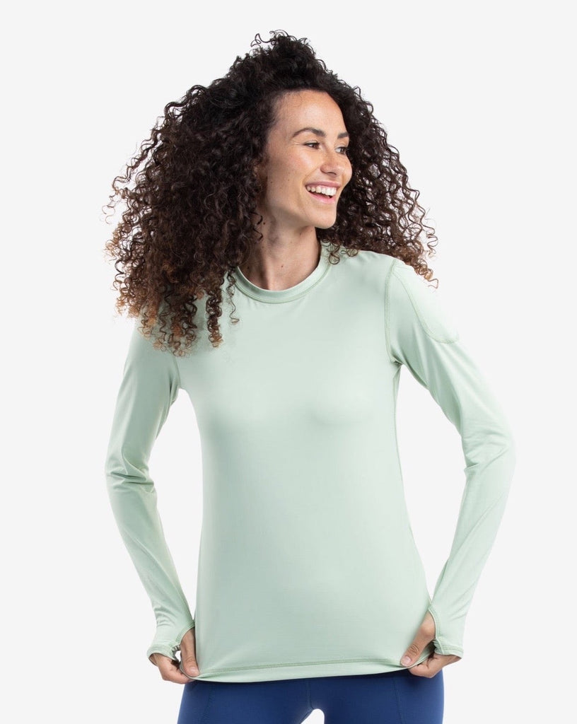 Women wearing sage long sleeve 24/7 shirt with navy tights. (Style 2001) - BloqUV