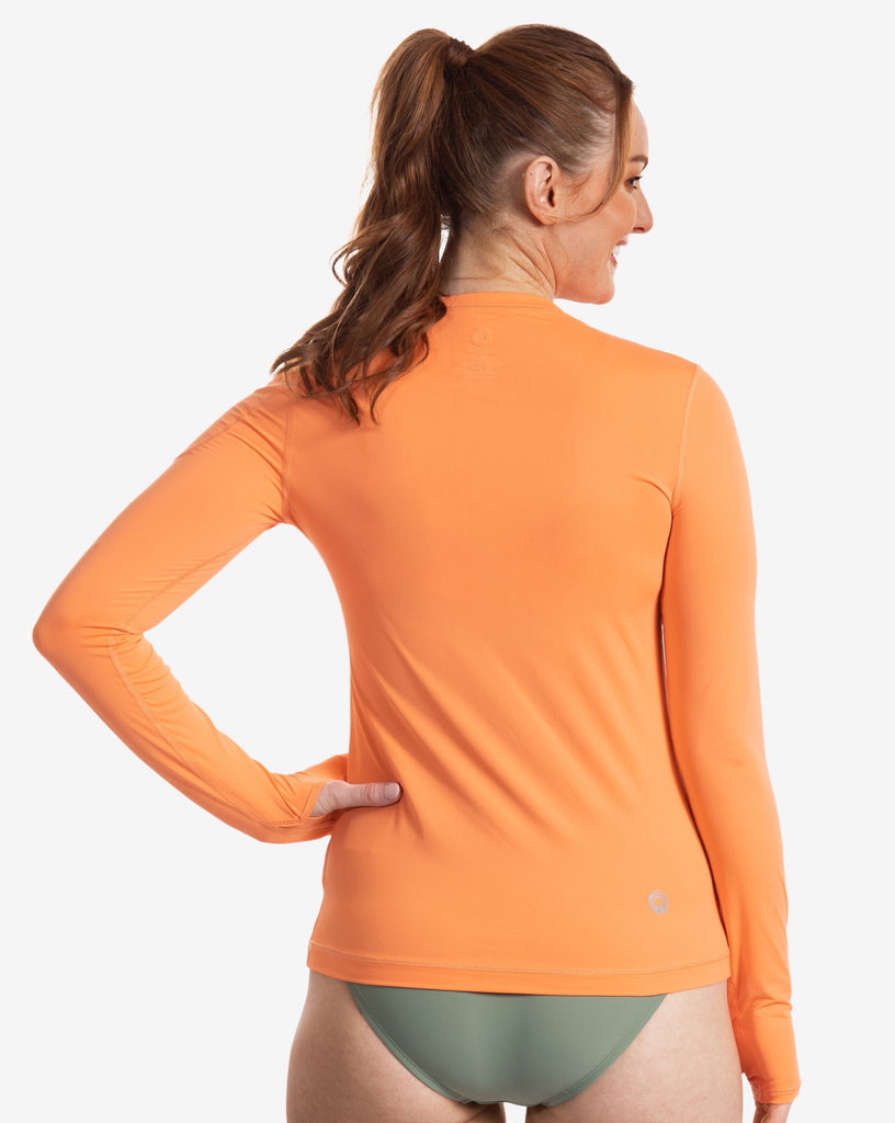 Women wearing tangerine long sleeve 24/7 shirt with bathing suit bottom leggings. Picture shows back of shirt. (Style 2001) - BloqUV