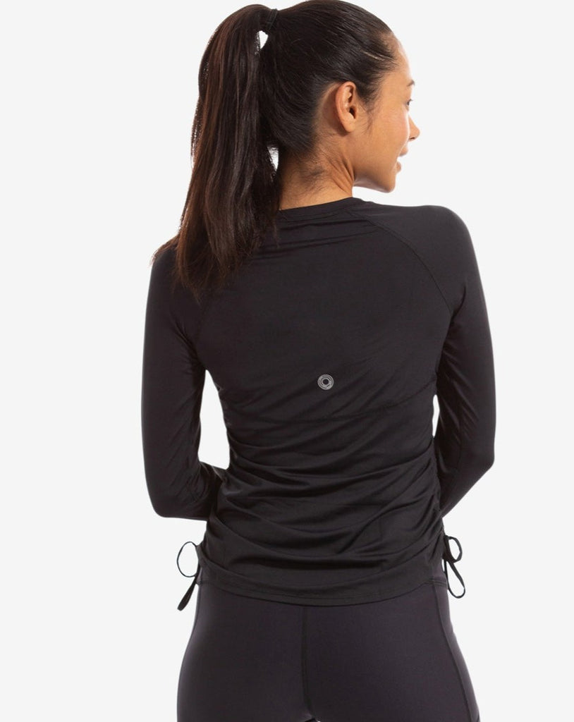 Women wearing black long sleeve drawstring crew with black tights. Picture shows back of shirt. (Style 2006) - BloqUV