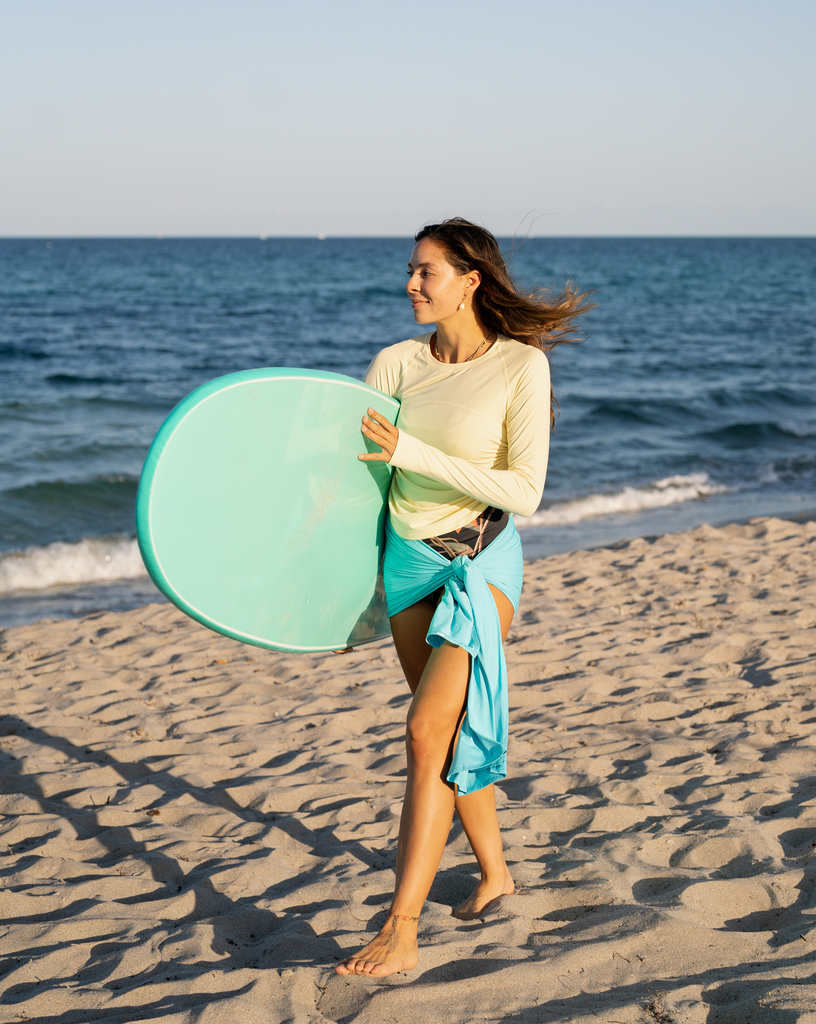 Women wearing light turquoise blanket wrap as a skirt at the beach (Style 5000) - BloqUV