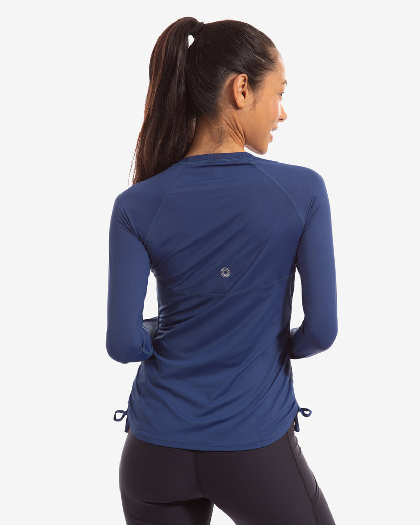 Women wearing navy long sleeve drawstring crew with black tights. Picture shows back of shirt. (Style 2006) - BloqUV