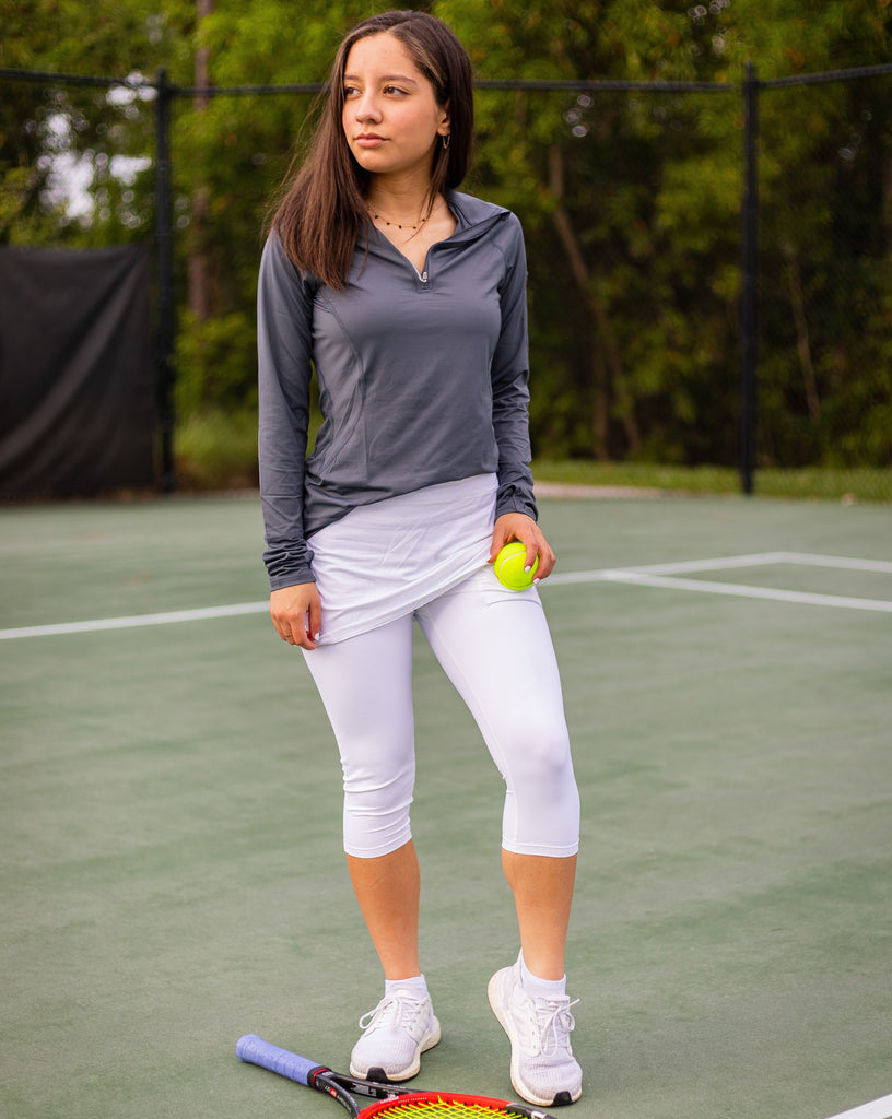 Women playing tennis wearing white capri skort with smoke mock zip top. (Style 6002) - BloqUV