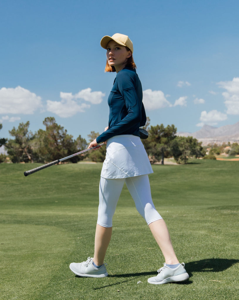 Women playing golf wearing midnight blue top with white skort. (Style 3001) - BloqUV