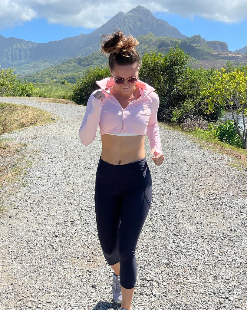 Women running outdoors wearing tickle me pink full zip crop top with black leggings. (Style 4010) - BloqUV