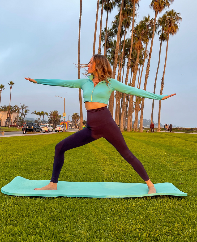 Women doing yoga wearing caribbean blue full zip crop top with black tights. (Style 4010) - BloqUV