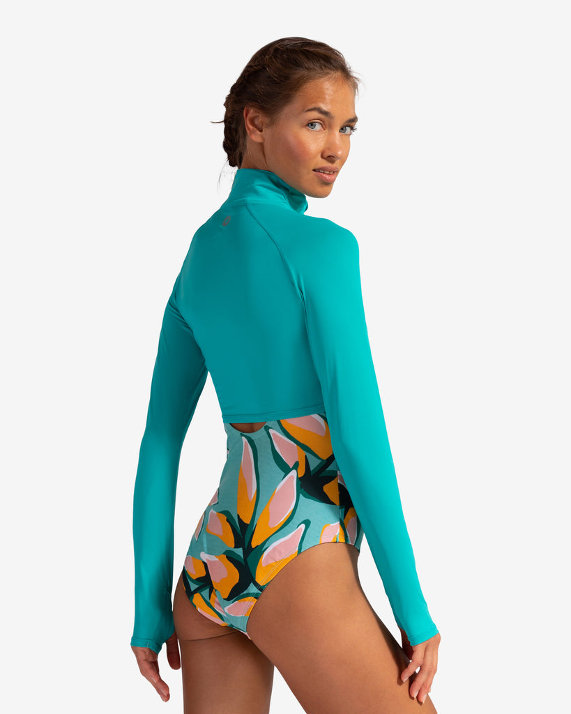 Women wearing caribbean blue full zip crop top over printed swimsuit. Picture shows back of shirt (Style 4010) - BloqUV