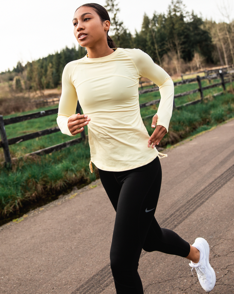 Women running outside wearing lemon yellow long sleeve drawstring crew with black tights.  (Style 2006) - BloqUV