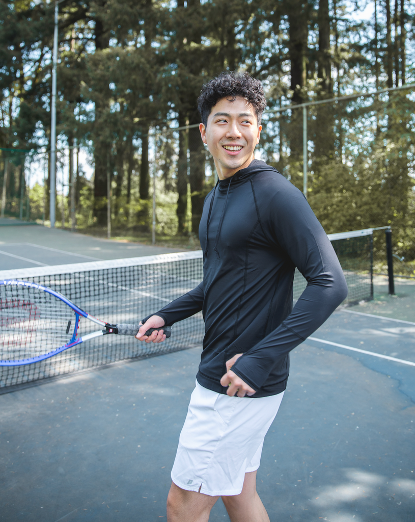 Man playing tennis wearing black color unisex long sleeve hoodie shirt. (Style 12007) - BloqUV