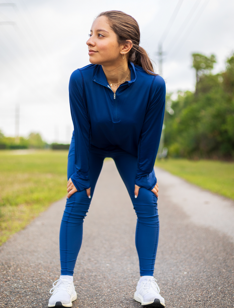 Women stretching outdoors wearing navy relaxed mock zip top with navy leggins. (Style 3002) - BloqUV