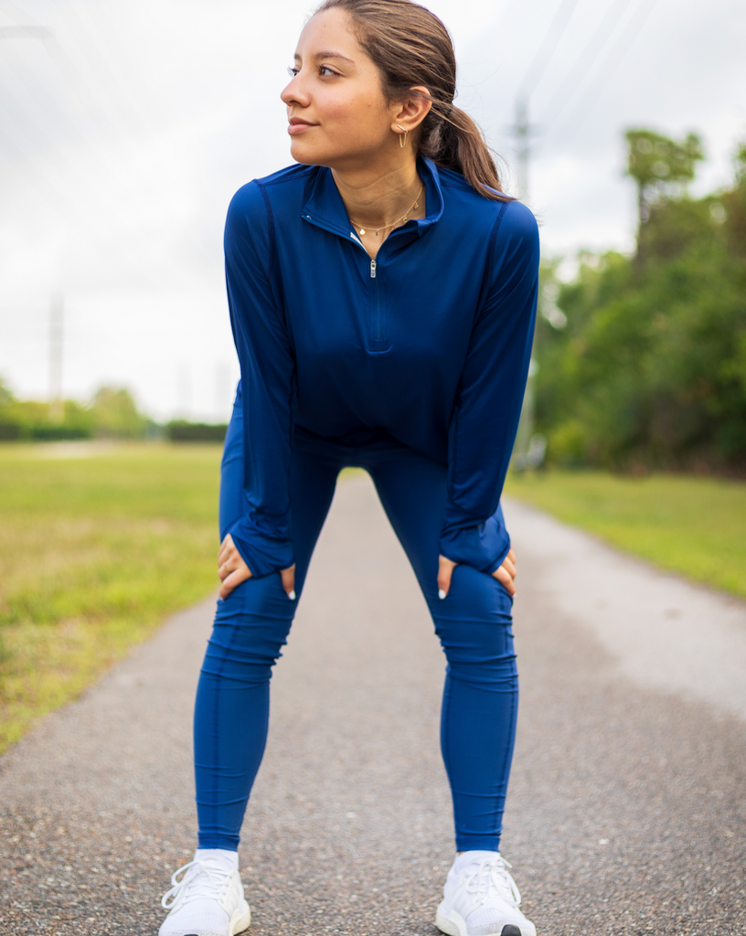 Women stretching outdoors wearing navy relaxed mock zip top with navy leggins. (Style 3002) - BloqUV