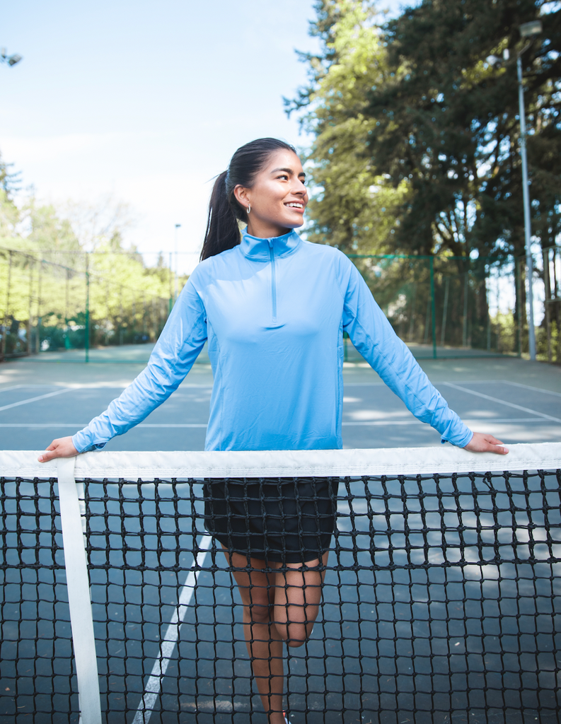 Women at tennis court wearing indigo relaxed mock zip top. (Style 3002) - BloqUV