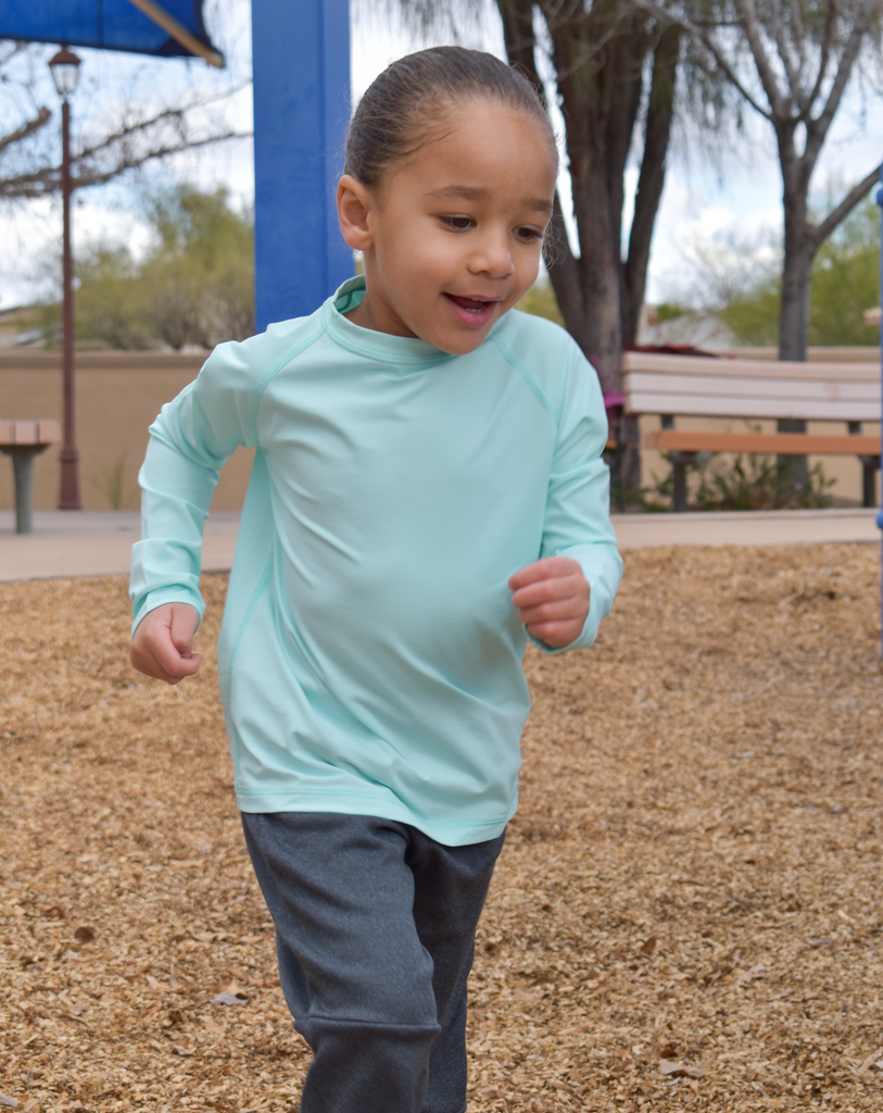 Girl wearing mint color top while playing at the park. (Style 1005K) - BloqUV